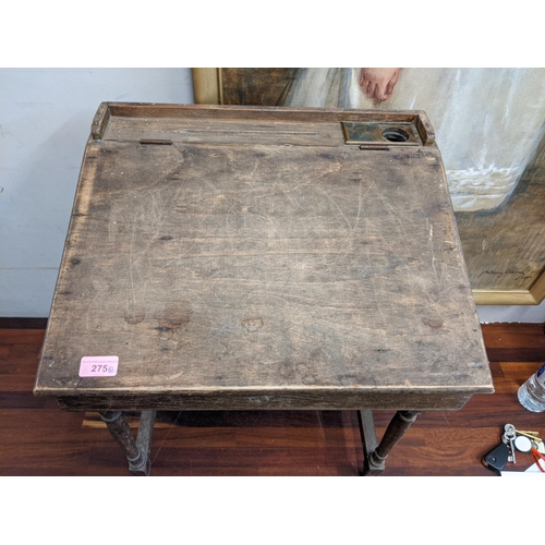 141 - A mixed lot to include an early/mid 20th century child's desk with a hinged top, raised on tapered l... 