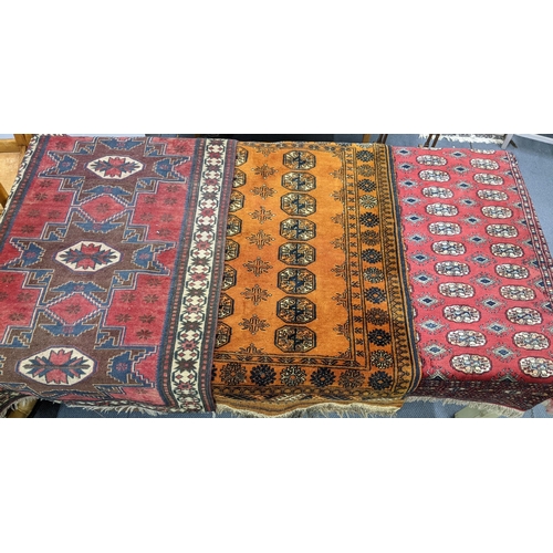 159 - Three rugs to include a Bokhara red ground rug with elephant foot motifs and multiguard borders A/F
... 