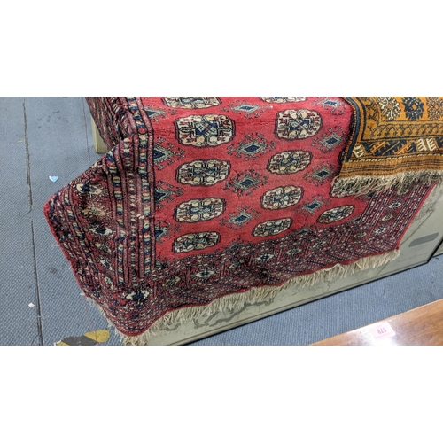 159 - Three rugs to include a Bokhara red ground rug with elephant foot motifs and multiguard borders A/F
... 