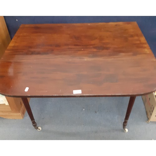 207 - An early 20th century mahogany Pembroke table with drop down sides and fluted legs on castors and an... 