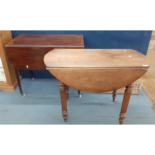 207 - An early 20th century mahogany Pembroke table with drop down sides and fluted legs on castors and an... 