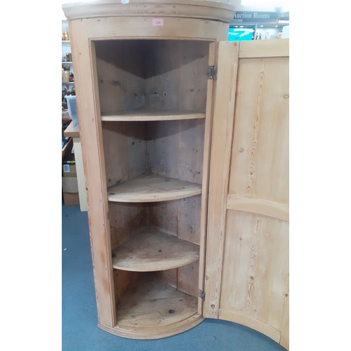 208 - An early 20th century stripped pine corner cabinet with internal shelves, 61