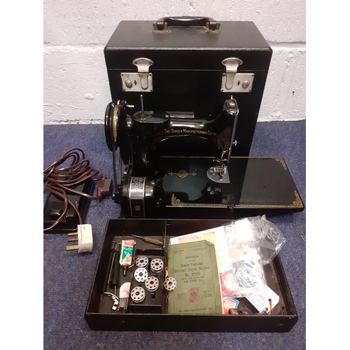 17 - A 1949 Singer 221K electric sewing machine serial no: EF560890 with accessories and black case, spoo... 