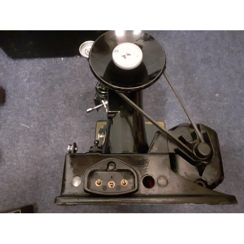 17 - A 1949 Singer 221K electric sewing machine serial no: EF560890 with accessories and black case, spoo... 