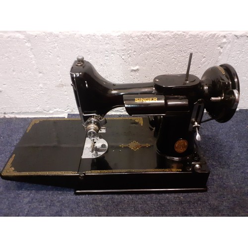 17 - A 1949 Singer 221K electric sewing machine serial no: EF560890 with accessories and black case, spoo... 