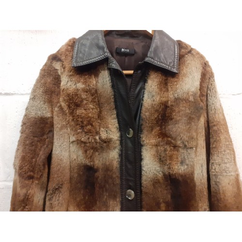 18 - Hugo Boss- A 1980's Press Sample of a brown beaver fur coat with brown leather trim, approx 36