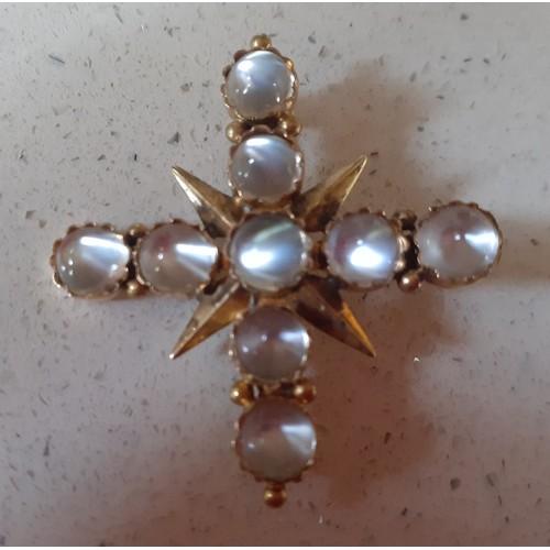 28 - A yellow metal and moonstone brooch in the form of a crucifix, total weight 5.9g. Location:Cab