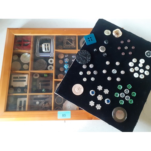 85 - A pine tabletop display case with partitions artistically filled with mounted vintage buttons and bu... 