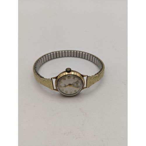 297 - A 9ct gold vintage ladies Accurist manual wind wrist watch and a gold plated expanding bracelet 
Loc... 