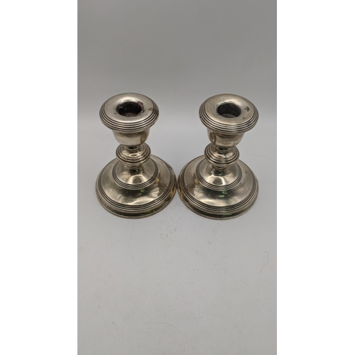 73 - A pair of silver WI Broadway and Co weighted candlesticks hallmarked Birmingham 1965 
Location: A3B
... 