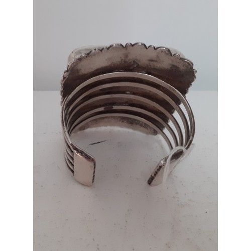 91 - An oversized white metal and turquoise effect cuff bracelet. Location:R1.2