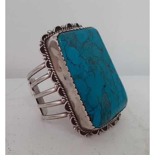 91 - An oversized white metal and turquoise effect cuff bracelet. Location:R1.2