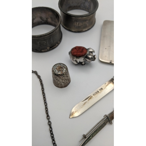 18 - silver to include a decanter label, tooth pick, whistle, note book and pepper pot along with a white... 