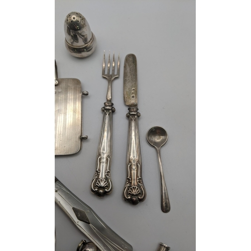 18 - silver to include a decanter label, tooth pick, whistle, note book and pepper pot along with a white... 