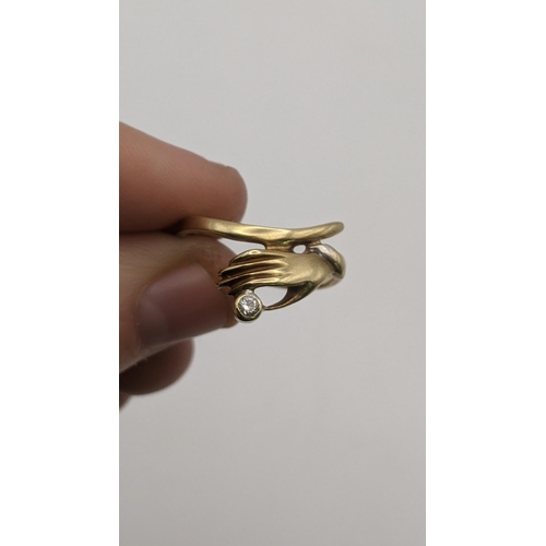62 - Three gold ladies rings to include a 14ct gold and diamond ring fashioned as a hand, a 9ct gold retr... 
