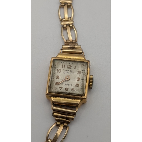 69 - An Imaco mid 20th century ladies 18ct gold manual wind wristwatch, total weight 11.7g, on a gold pla... 