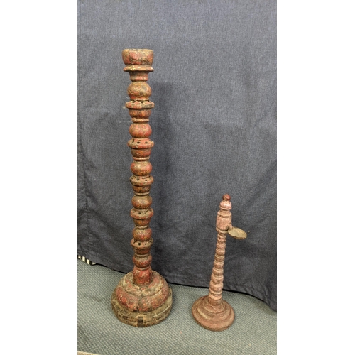 168 - Two 19th century Indian items to include a carved candle stand, 95cm h together with a carved candle... 