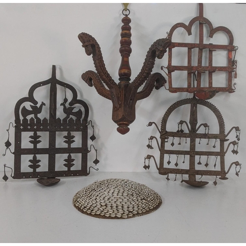 176 - Three Indian wall hanging oil lamp stands together with a wooden carved hanging centrepiece, and one... 