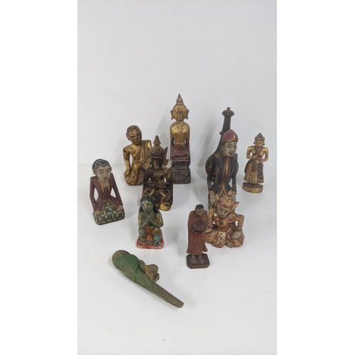 177 - A mixed lot of treen carved figures to include a gilt painted Buddha and others
Location:7.2
If ther... 