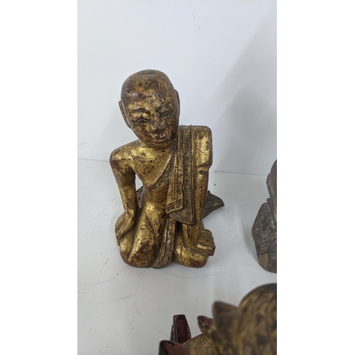 177 - A mixed lot of treen carved figures to include a gilt painted Buddha and others
Location:7.2
If ther... 