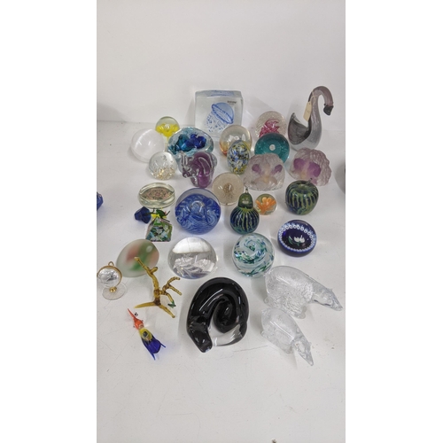 234 - A collection of various paperweights to include two Mdina paperweights, and others to include Swan A... 