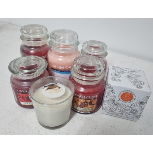 302 - A mixed lot to include a selection of Yankee Candles and others, glass candlesticks, an Italian mid-... 