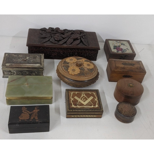 305 - A group of treen boxes to include an Indian deep carved box with hinged lid, a Masonic inlaid box, a... 