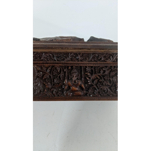 305 - A group of treen boxes to include an Indian deep carved box with hinged lid, a Masonic inlaid box, a... 