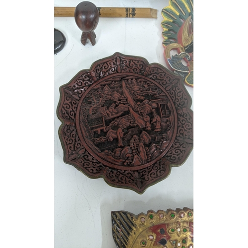 306 - A mixed lot to include a Chinese cinnabar lacquered wall hanging plaque, wall hanging painted treen ... 