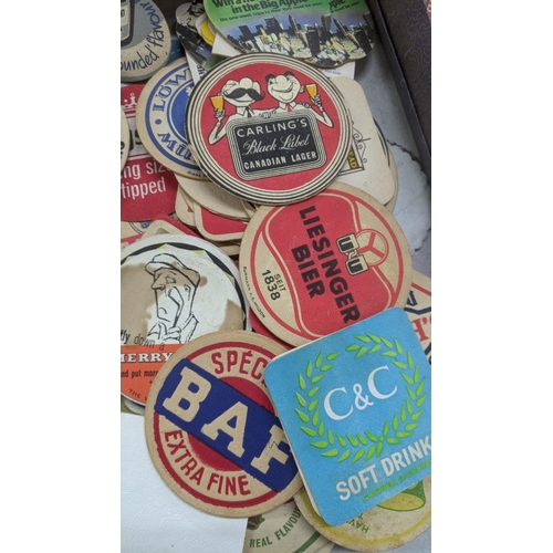 311 - A quantity of vintage matchboxes and beer coasters to include Bass, Heineken, Carling and others Loc... 