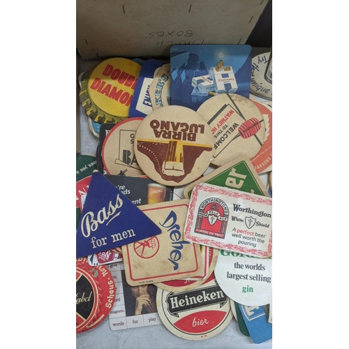 311 - A quantity of vintage matchboxes and beer coasters to include Bass, Heineken, Carling and others Loc... 