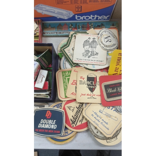 311 - A quantity of vintage matchboxes and beer coasters to include Bass, Heineken, Carling and others Loc... 