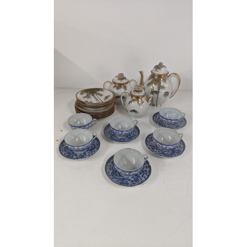 314 - A 20th century Japanese part tea service with a set of 5 blue and white cups and saucers, and others... 