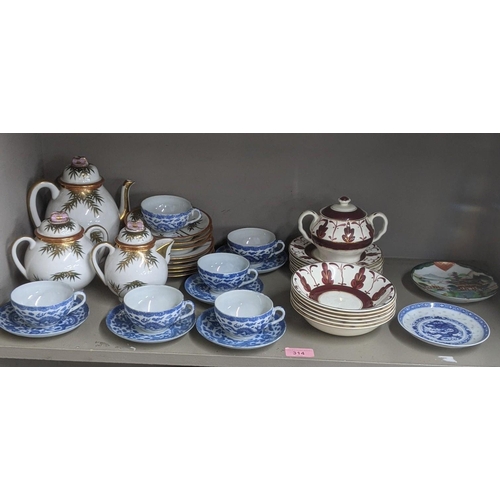 314 - A 20th century Japanese part tea service with a set of 5 blue and white cups and saucers, and others... 