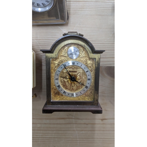 372 - A group of mixed travel clocks to include a Cartier gilt metal octagonal travel clock, a silver face... 