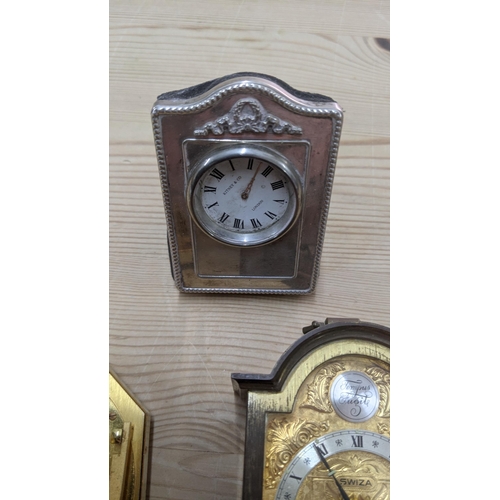 372 - A group of mixed travel clocks to include a Cartier gilt metal octagonal travel clock, a silver face... 