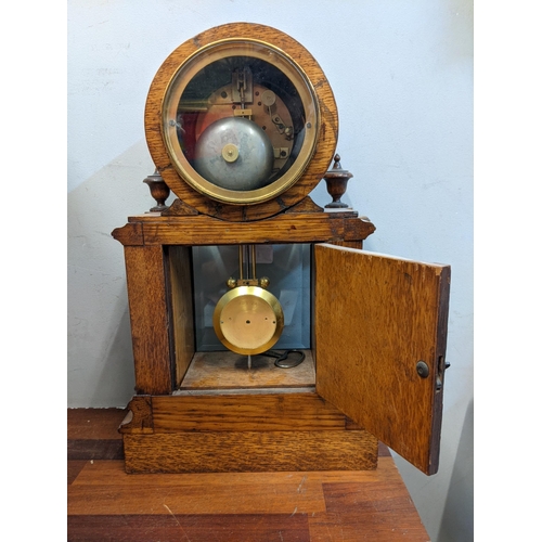 1 - An early 20th century mantel clock with a Roman dial, with a pendulum and key, in a partially glazed... 