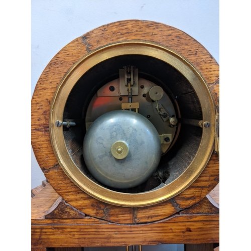 1 - An early 20th century mantel clock with a Roman dial, with a pendulum and key, in a partially glazed... 