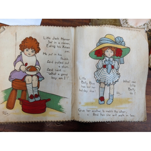 11 - Books and printed ephemera to include two children's books printed on cloth, the motor journal bookl... 