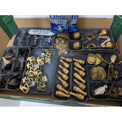 121 - A mixed lot of door furniture, light palls, picture hooks, door knobs, and other items, along with a... 