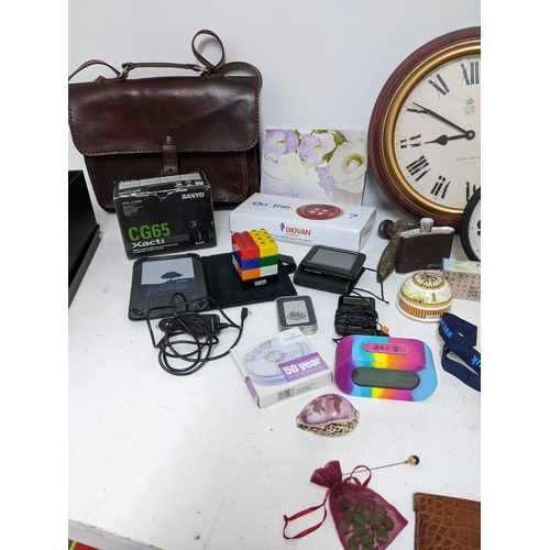 125 - A mixed lot to include wall clocks, Amazon Kindle, silver plated cigarette box, Zefer brown leather ... 