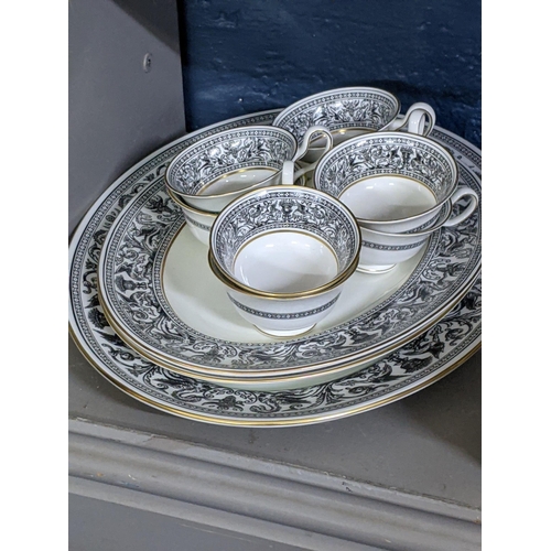 293 - A Wedgwood Florentine pattern part dinner service to include three oval meat dishes, a gravy boat an... 