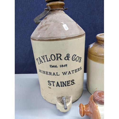 320 - Stoneware to include a 'Taylor & Co Mineral Waters, Staines' tapped flagon, a Burge & Co Ltd Windsor... 