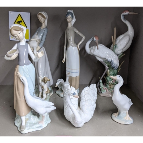 322 - Six Lladro figures to include a model of two storks, a model of a swan, a goose, a girl holding a go... 