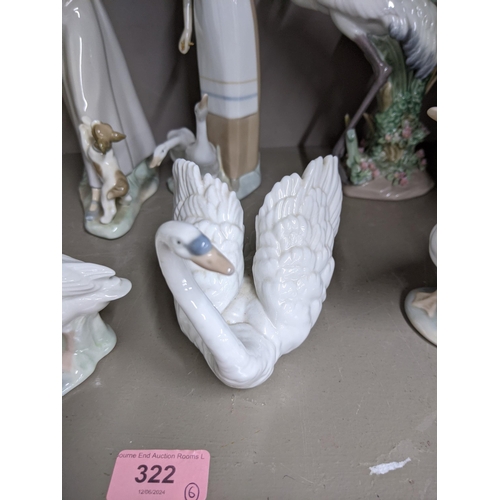 322 - Six Lladro figures to include a model of two storks, a model of a swan, a goose, a girl holding a go... 