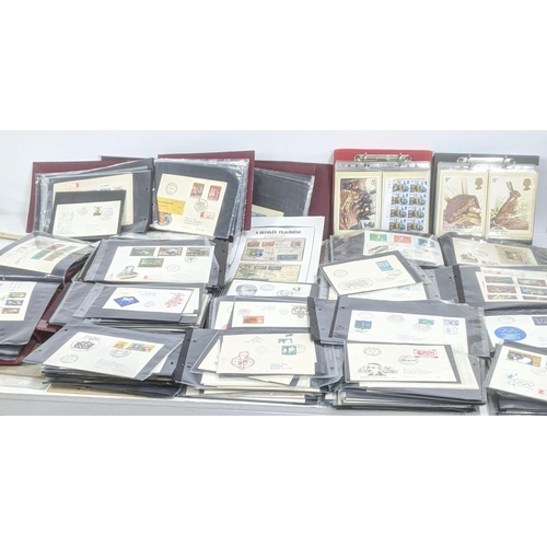 374 - A large quantity of first day covers from around the world along with two albums of Post Office post... 