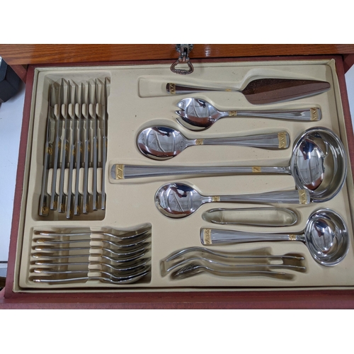 38 - A cased canteen of SBS International stainless steel cutlery, all with bi-coloured design, 86 pieces... 