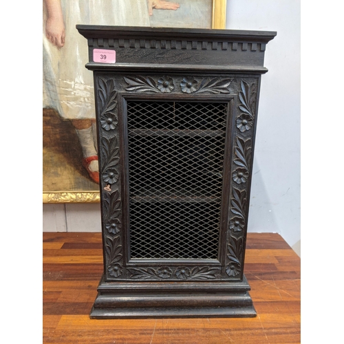 39 - An early 20th century carved wooden cabinet with a wire mesh door and sides Location: G
If there is ... 