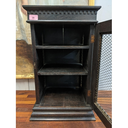 39 - An early 20th century carved wooden cabinet with a wire mesh door and sides Location: G
If there is ... 