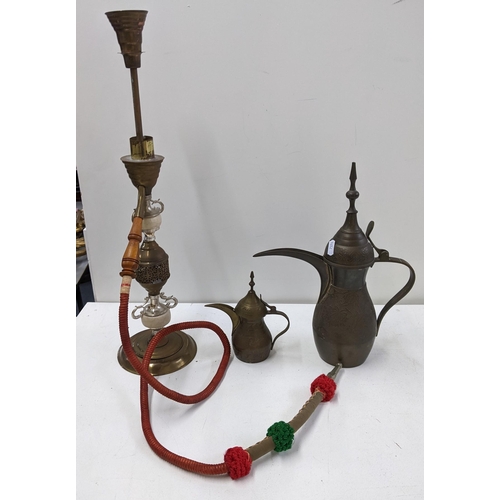 399 - Mixed Qatari items to include two dallah brass coffee pots, and a Shisha pipe Location:10.1
If there... 